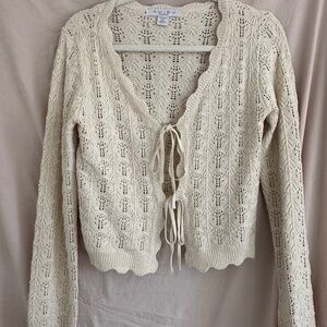 Cream colored long sleeve coquette top